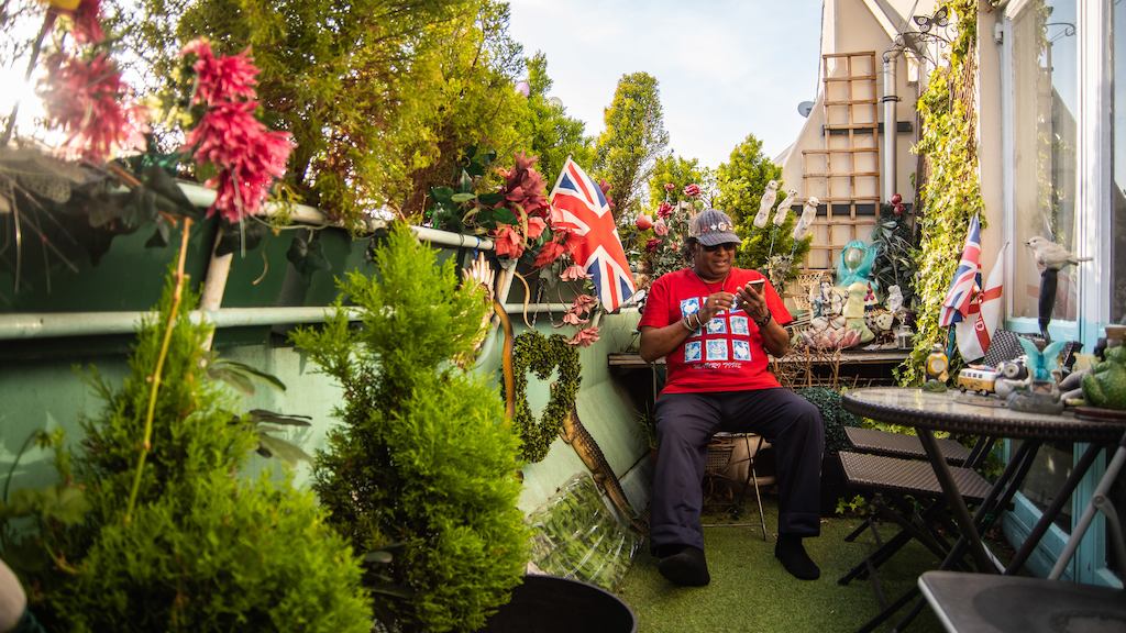 Older man in garden using phone