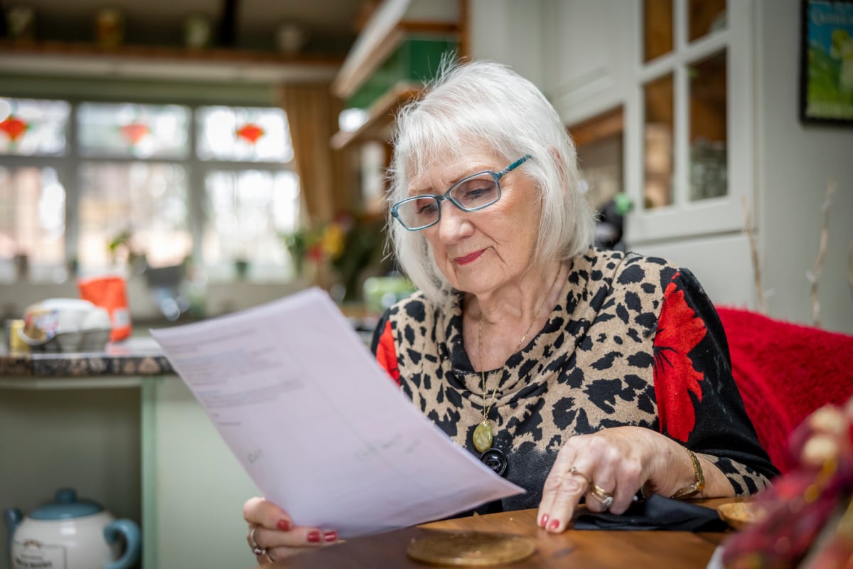 A woman reading a bill
