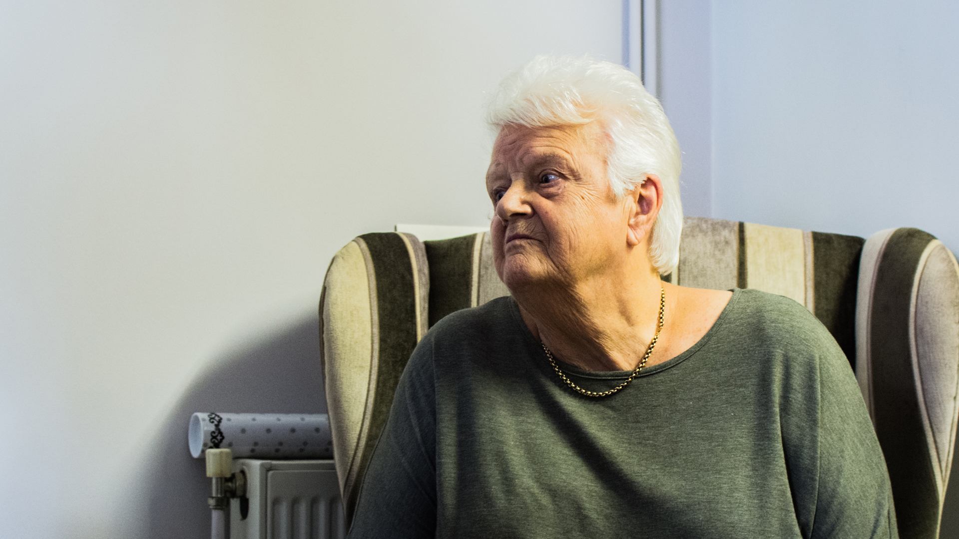 Woman sitting in armchair at home