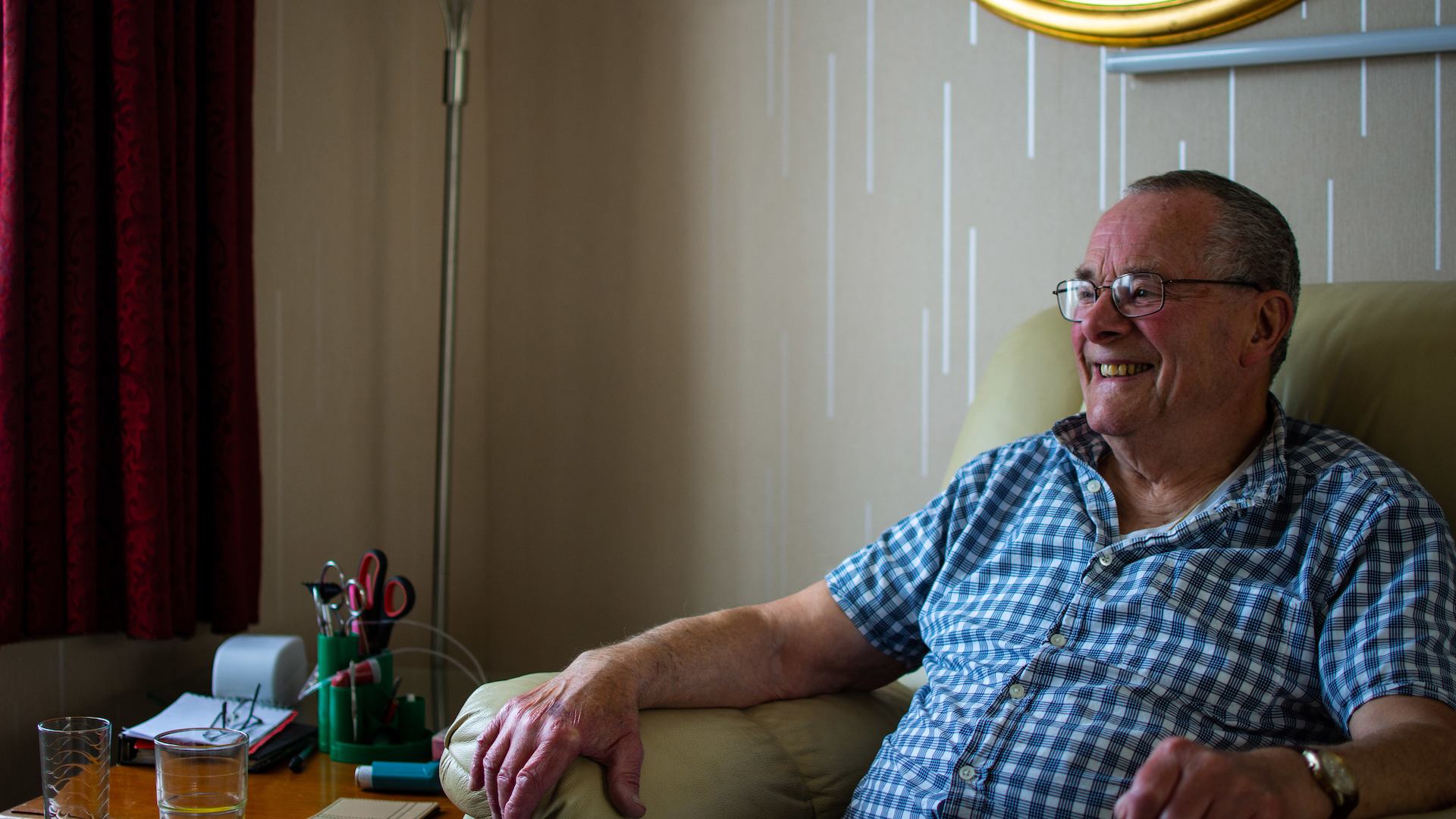 Older man sitting on chair in home