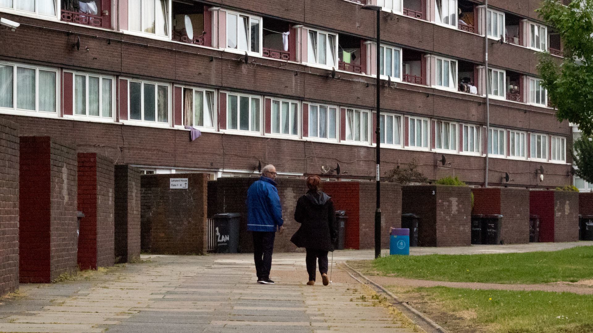 Man and woman walking on an estate.