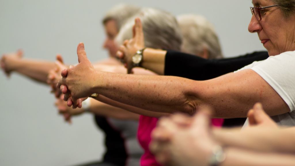 Woman exercising with outstretched arms