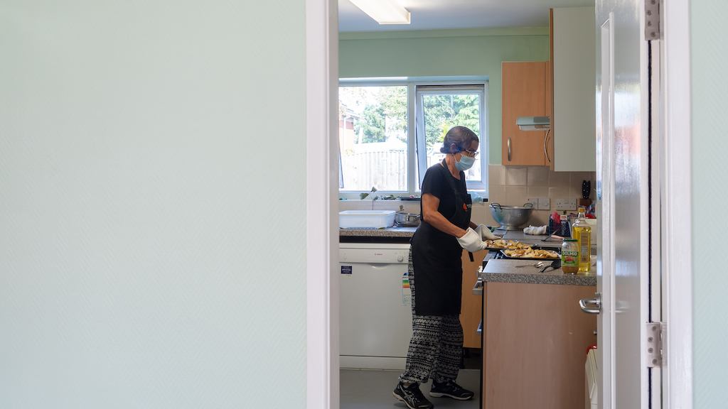 Woman preparing food in a community kitchen