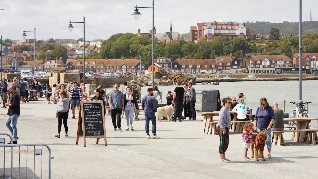 Landscape of seaside town and people mingling