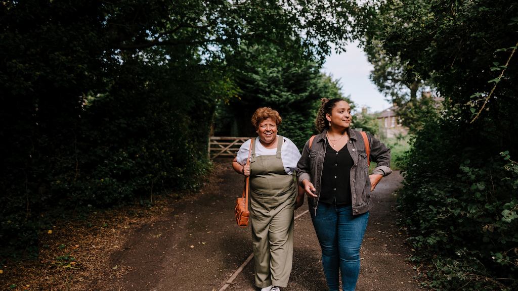 Older and younger people walking together