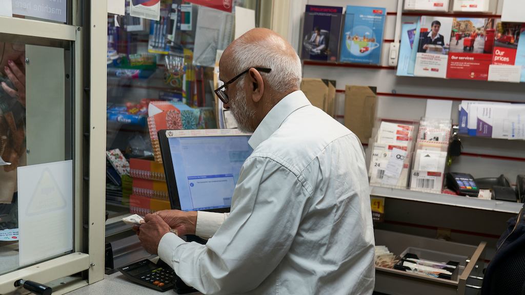 an older worker in the post office