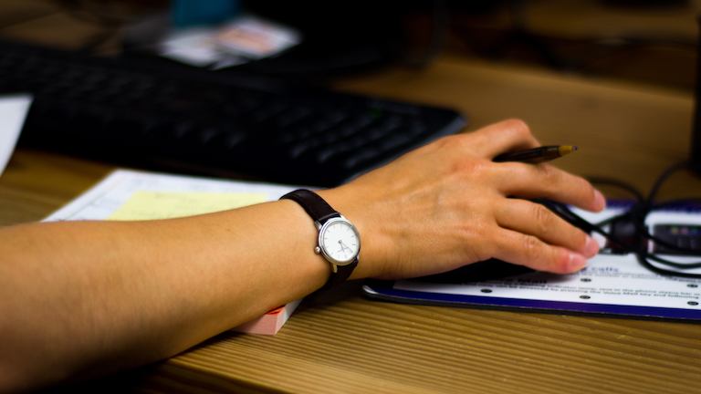 Woman's hand on computer mouse.