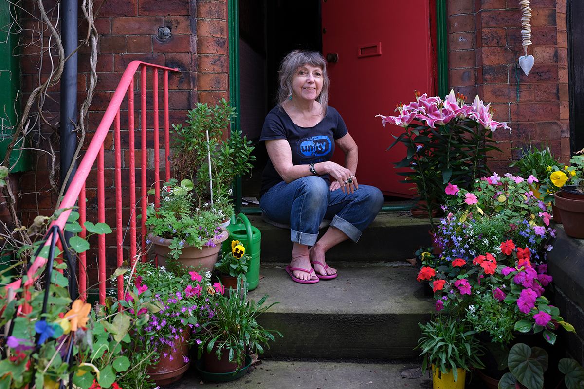 Sue, posing on her garden steps