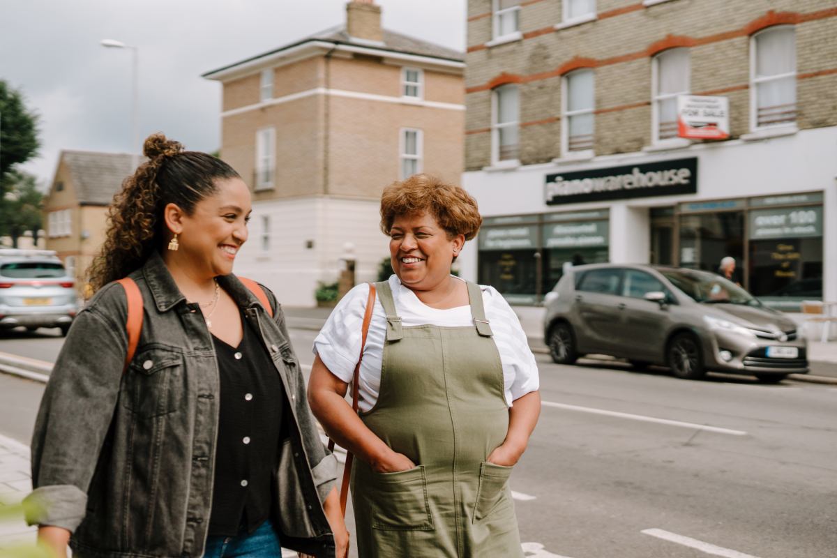 Older and younger woman walking together