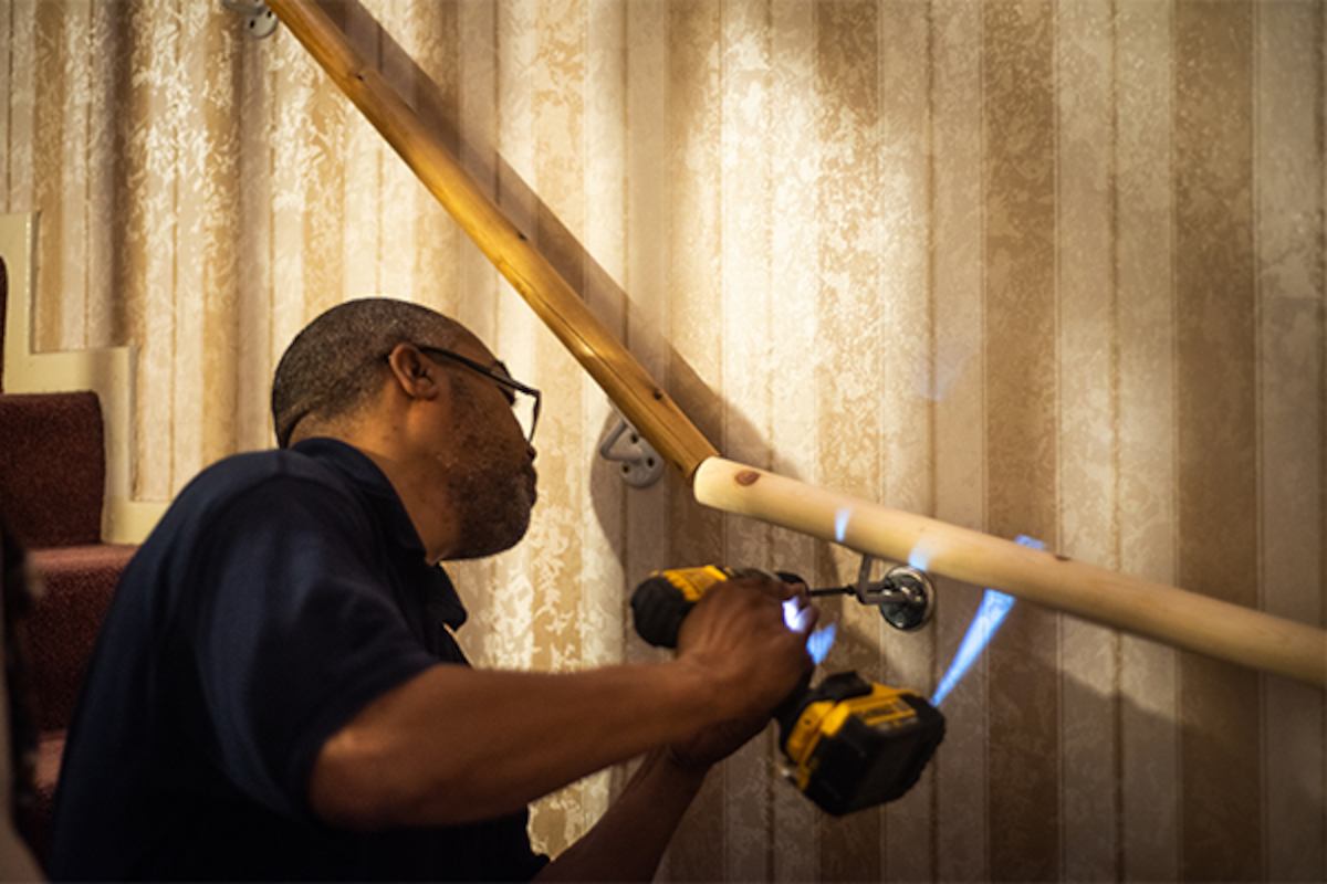 Handyman installing housing adaptation