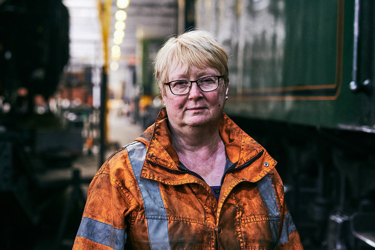 Older woman standing by railway