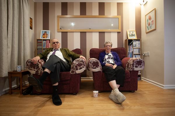 Older couple sitting at home